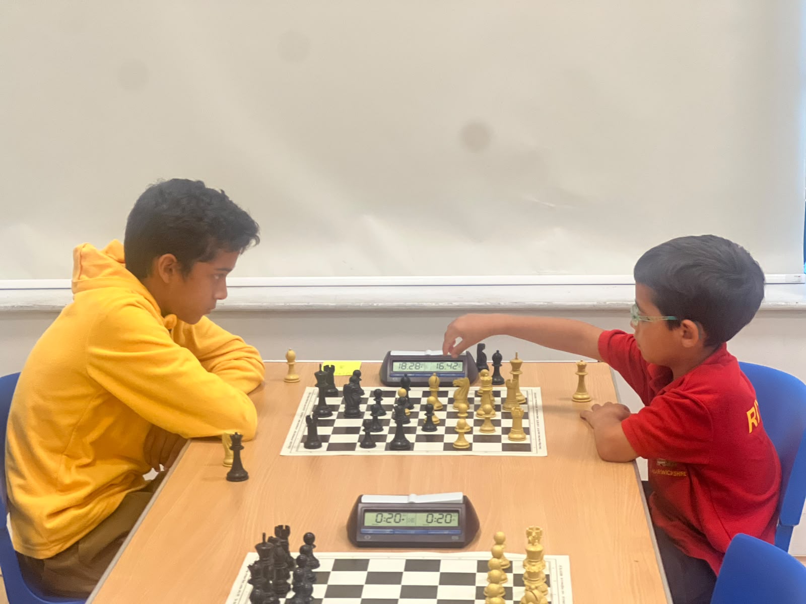 Chess players seated at boards during an A3C club session