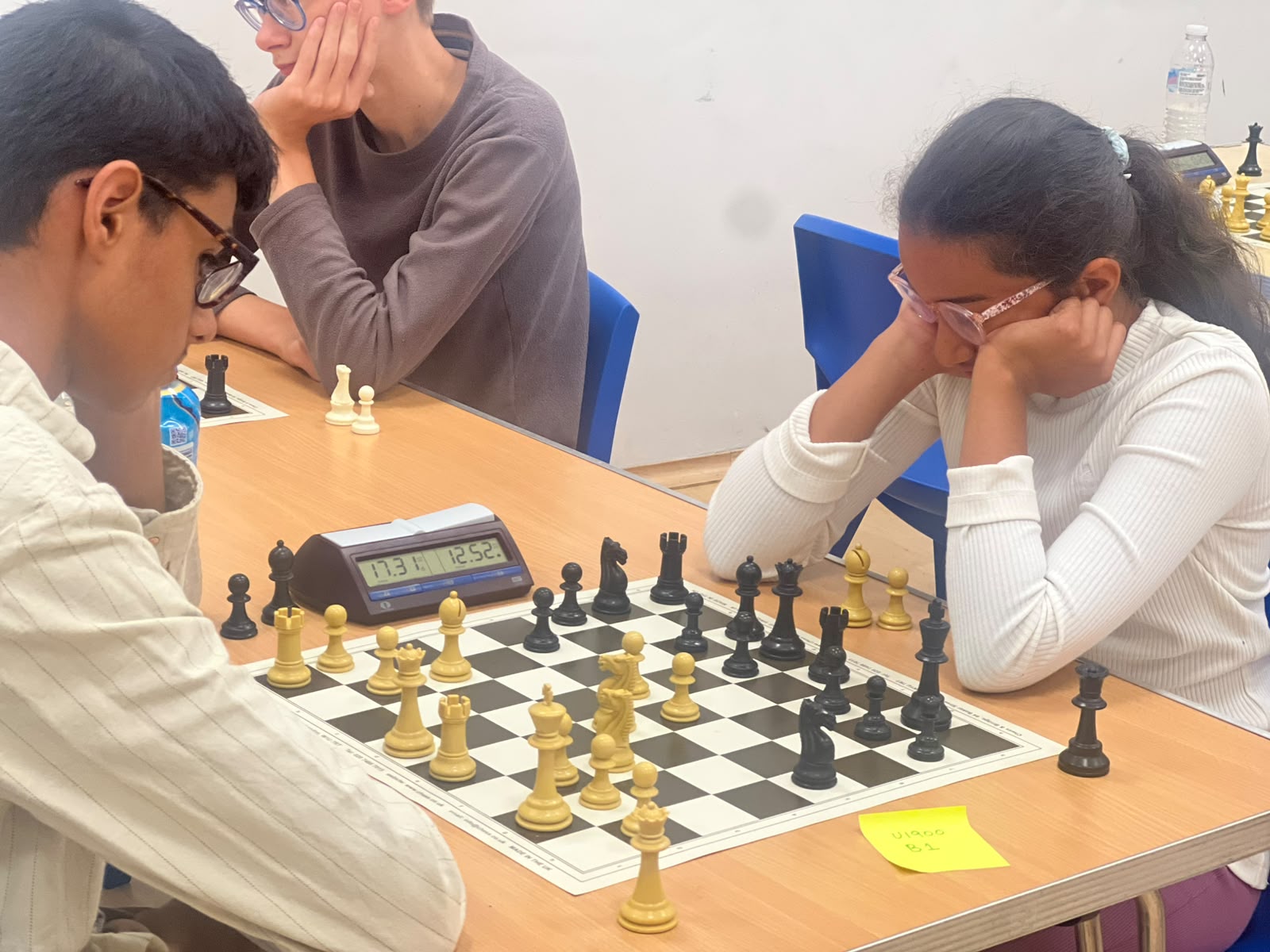 Chess players seated at boards during an A3C club session