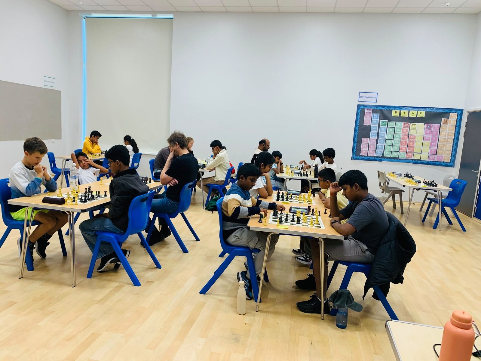 Chess players seated at boards during an A3C club session