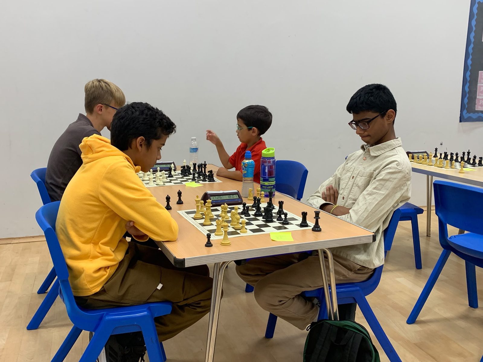 Chess players seated at boards during an A3C club session