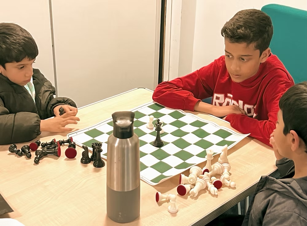 Junior members focused on a game